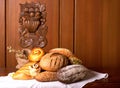 Wicker basket with different types of bread on wooden table Royalty Free Stock Photo