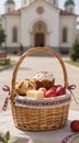 Wicker basket with easter eggs and breads placed by church Royalty Free Stock Photo