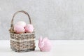 Wicker basket with Easter eggs and ceramic rabbit figure Royalty Free Stock Photo