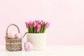 Wicker basket with Easter eggs and ceramic rabbit figure Royalty Free Stock Photo