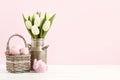 Wicker basket with Easter eggs and ceramic rabbit figure Royalty Free Stock Photo