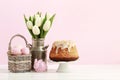 Wicker basket with Easter eggs and ceramic rabbit figure Royalty Free Stock Photo