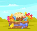 Wicker basket with Easter painted eggs and cake, spring tulips, gingerbread rabbit, yellow chicken Royalty Free Stock Photo