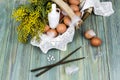 Wicker basket with eggs, branches of mimosa, holy water, church candles and incense