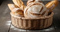 A wicker basket filled with assorted artisanal breads, featuring a round loaf with a Royalty Free Stock Photo
