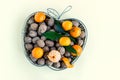 Wicker basket is filled with walnuts and bright tangerines.