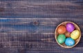 A wicker basket with five colored Easter eggs Royalty Free Stock Photo