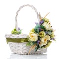 Wicker basket with floral composition in olive color. Decor with light flowers, lavender, green and ribbon. Isolated Royalty Free Stock Photo