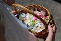 Wicker basket with flower petals in the hands of a girl Royalty Free Stock Photo