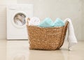 Wicker basket with fresh rolled towels in bathroom