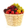 Wicker basket with mixed summer fruit Royalty Free Stock Photo