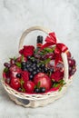 Wicker basket with fruit and a bottle of wine, beautifully decorated on a light background. concept., congratulations for a holida Royalty Free Stock Photo