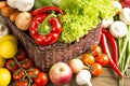 Wicker basket with fruits and vegetables on wooden table Royalty Free Stock Photo