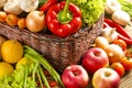 Wicker basket with fruits and vegetables on wooden table Royalty Free Stock Photo