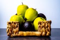 Wicker basket full of apples and avocados Royalty Free Stock Photo