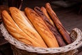 Wicker basket full of baguettes, tasty delicious crusty bread in bakery shopfront Royalty Free Stock Photo