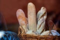 Wicker basket full of baguettes, tasty delicious crusty bread in bakery shopfront Royalty Free Stock Photo