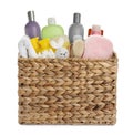 Wicker basket full of different baby cosmetic products, bathing accessories and toy on white background Royalty Free Stock Photo
