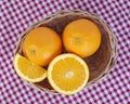 A wicker basket full of fresh orange fruits Royalty Free Stock Photo