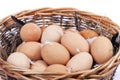 A wicker basket full of homemade organic eggs isolated on white Royalty Free Stock Photo