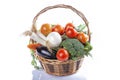 A wicker basket full of organic vegetables isolated Royalty Free Stock Photo
