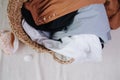 Wicker basket full with summer dresses for washing laungry. Royalty Free Stock Photo