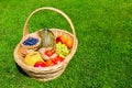 Wicker basket on grass filled with fruit