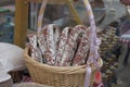 Wicker basket of italian sausage - traditional handmade organic salami in market. Gastronomic products for gourme Royalty Free Stock Photo