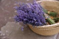 Wicker basket with lavender flowers on cement floor, closeup Royalty Free Stock Photo