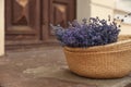 Wicker basket with lavender flowers on cement floor. Space for text Royalty Free Stock Photo