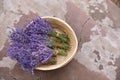 Wicker basket with lavender flowers on cement floor, top view. Space for text Royalty Free Stock Photo