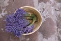 Wicker basket with lavender flowers on cement floor outdoors. Space for text Royalty Free Stock Photo