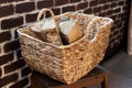 a wicker basket made of paper vine filled with firewood. recycling, eco, natural materials, eco-friendly. boho style