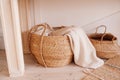 Wicker basket made of recycled materials with beige towel inside. smart storage. reasonable consumption of materials, monochrome