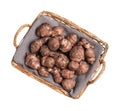 Wicker basket with many Jerusalem artichokes isolated on white, top view Royalty Free Stock Photo