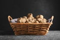 Wicker basket with many Jerusalem artichokes on light grey table Royalty Free Stock Photo