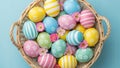 Wicker basket overflowing with vibrantly colored and patterned Easter eggs and delicate pink flowers Keywords Royalty Free Stock Photo