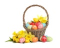 Wicker basket with painted Easter eggs and flowers Royalty Free Stock Photo