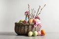 Wicker basket with painted Easter eggs and flowers Royalty Free Stock Photo