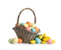 Wicker basket with painted Easter eggs and spring flowers Royalty Free Stock Photo