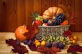 Wicker basket with pumpkins, autumn leaves and fresh fruits on wooden table Royalty Free Stock Photo