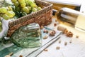 Wicker basket with ripe grapes and wineglasses on white table Royalty Free Stock Photo