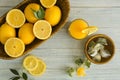 Wicker basket with ripe lemons and glass of fresh juice on wooden table Royalty Free Stock Photo