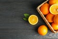 Wicker basket with ripe oranges on wooden table Royalty Free Stock Photo
