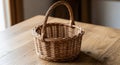 Wicker basket with a sturdy handle, made from light brown woven material, placed on a Royalty Free Stock Photo
