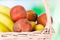 Wicker basket with summer fruits. Peaches and bananas. Healthy food. Royalty Free Stock Photo