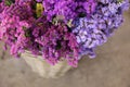 In a wicker basket variety of limonium sinuatum or statice salem flowers in pink, lilac, violet colors in the garden shop.