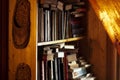 Wicker bast shoes hanging on a wooden bookshelf Royalty Free Stock Photo