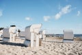 Wicker beach chairs on empty sandy beach Royalty Free Stock Photo