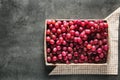 Wicker box with red fresh grapes on grey table Royalty Free Stock Photo